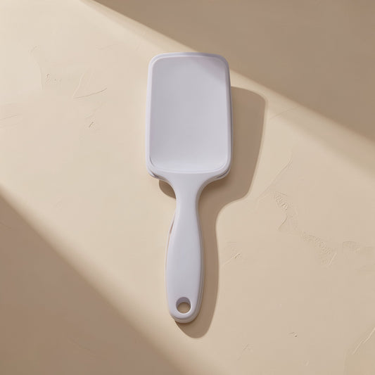 Plastic hairbrush with a large curved shape and hollow ribbed design - view 2