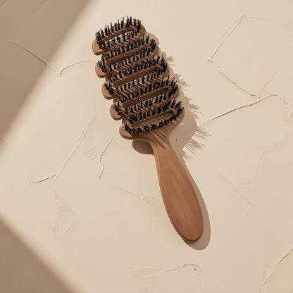 Boar-bristle hairbrush described as a ribbed comb, over 20 cm