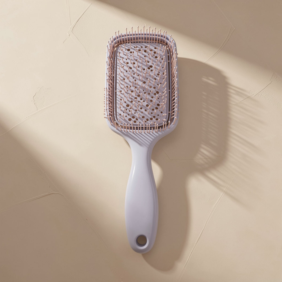 Plastic hairbrush with a large curved shape and hollow ribbed design - view 3