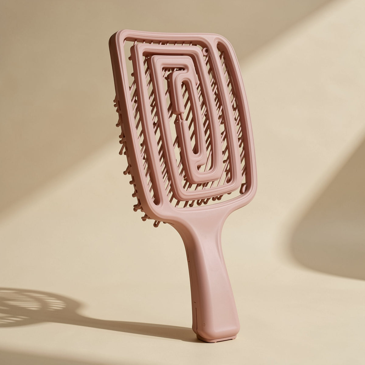 Plastic hairbrush with a large curved shape and hollow ribbed design - view 4